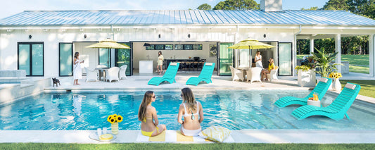 AquaCurve in-pool lounge chairs with matching poolside tables designed for shallow water pools and modern outdoor spaces