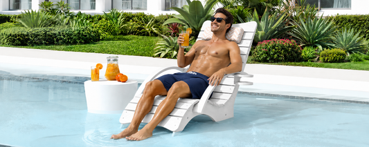In-pool lounge chair on a shallow tanning ledge with a side table for backyard pool relaxation