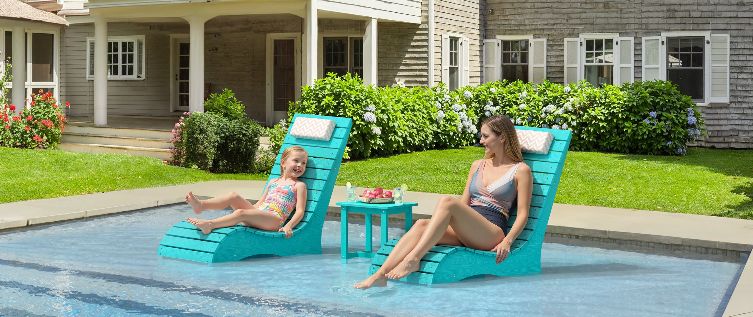pool lounger in water on a compact tanning ledge in a backyard pool
