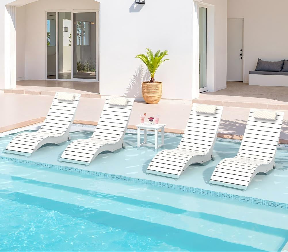 Finished residential sun shelf setup with in-pool lounge chairs and side table
