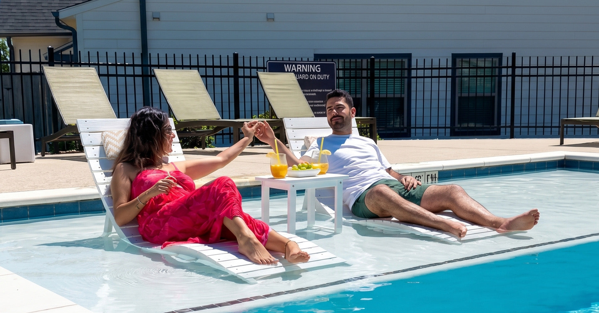 Load video: White in-pool lounge chairs on a tanning ledge in shallow water.