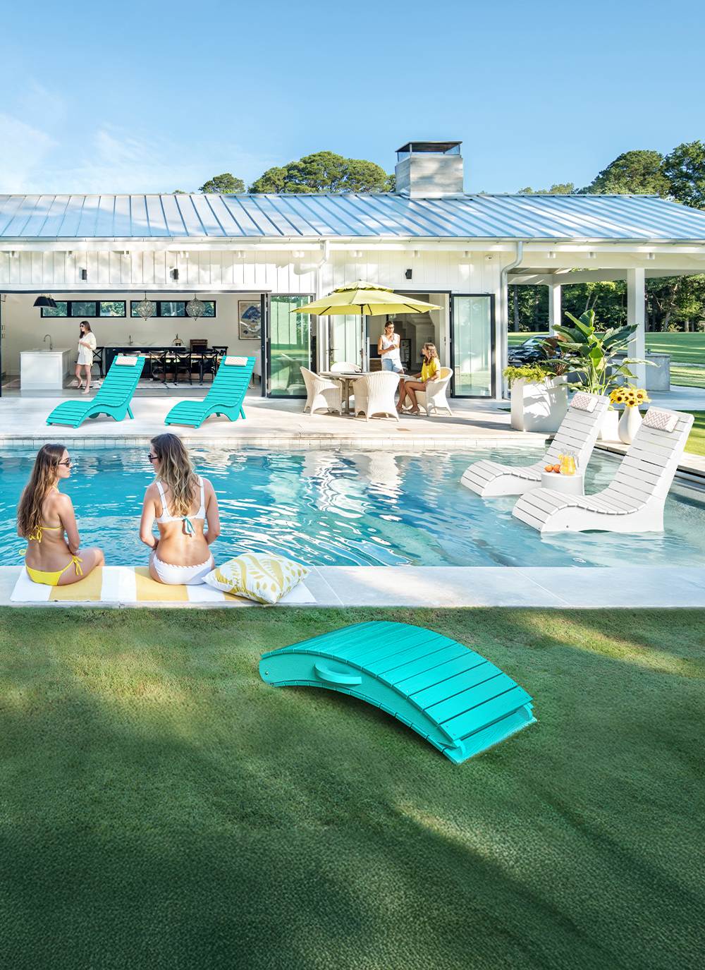 AquaCurve in-pool lounge chairs by a modern swimming pool with shallow water seating and poolside relaxation
