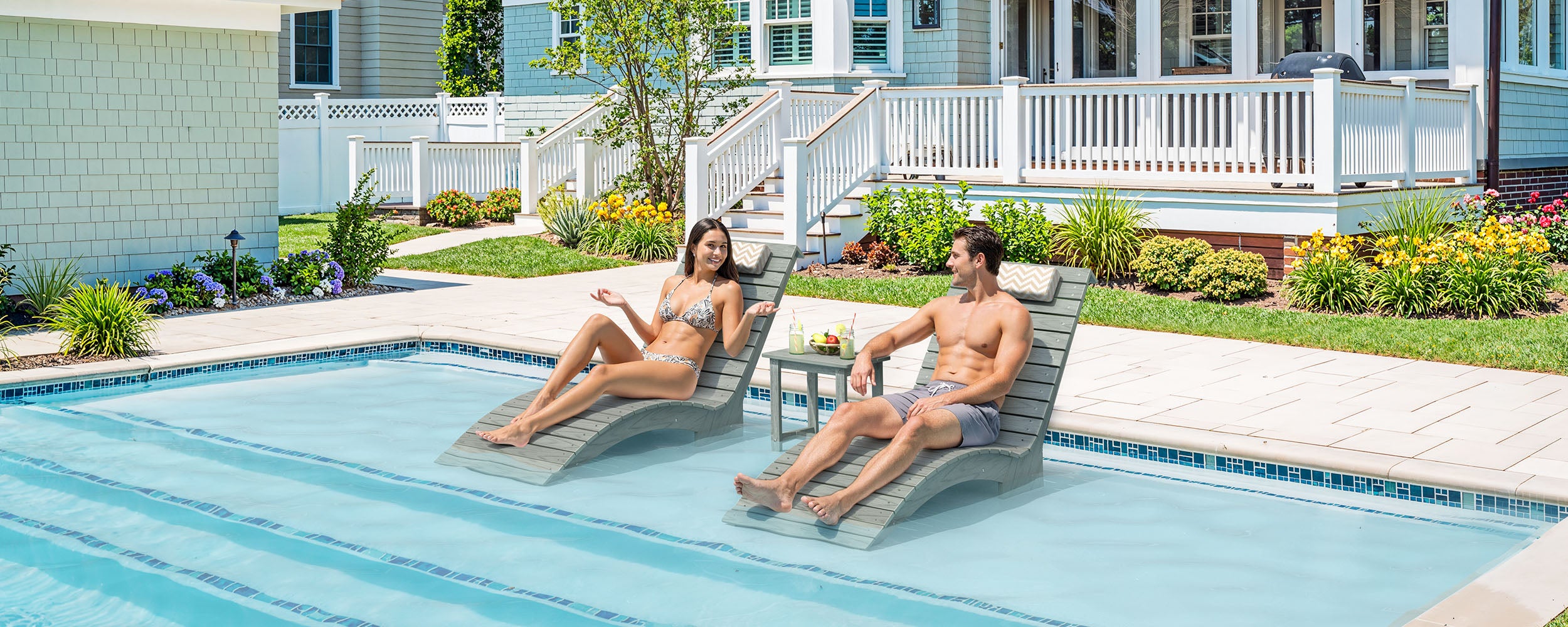 In-pool lounge chairs on a sun shelf showing spacing, layout, and fit for a tanning ledge