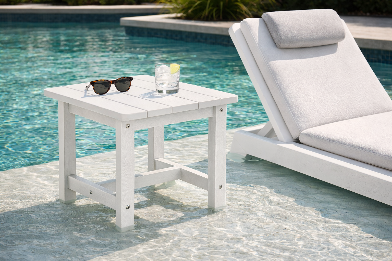 In-pool lounge chair paired with a compact side table on a sun shelf