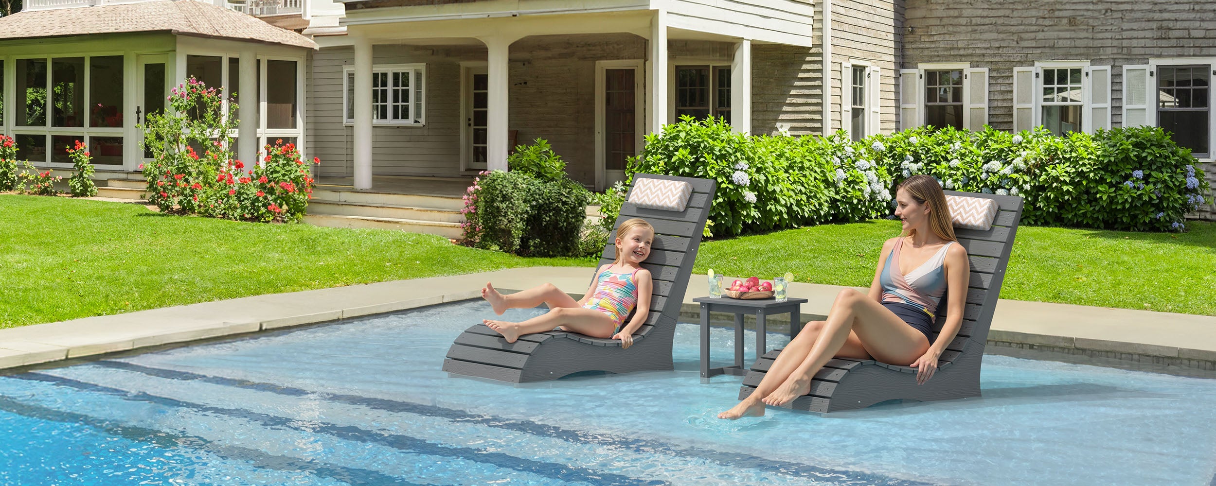 in-pool lounge chairs on a shallow tanning ledge designed for family pool use