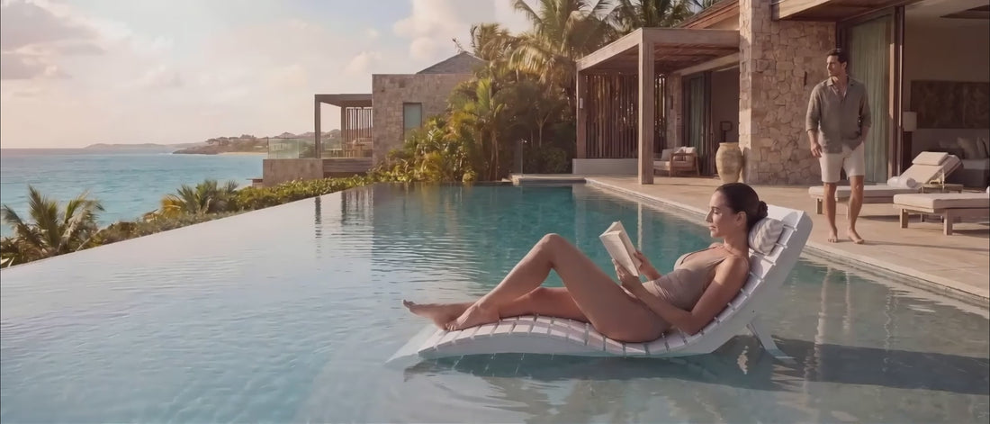 Load video: White in-pool lounge chairs on a tanning ledge in shallow water.
